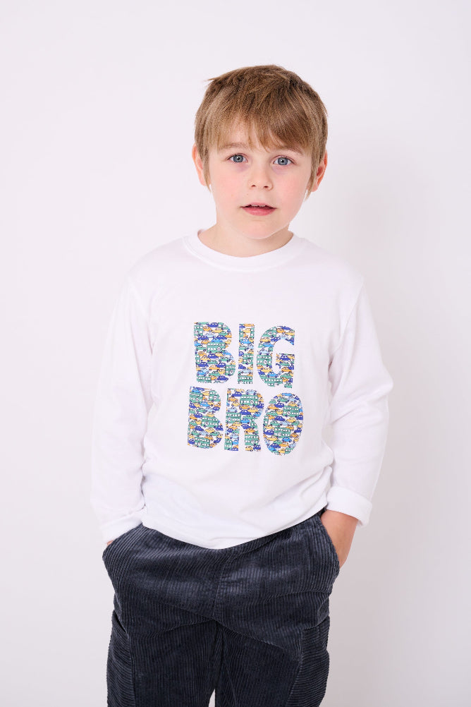 5 year old boy who is a Big Brother wearing a white cotton t-shirt with BIG BRO sewn onto it in vintage liberty cars print.