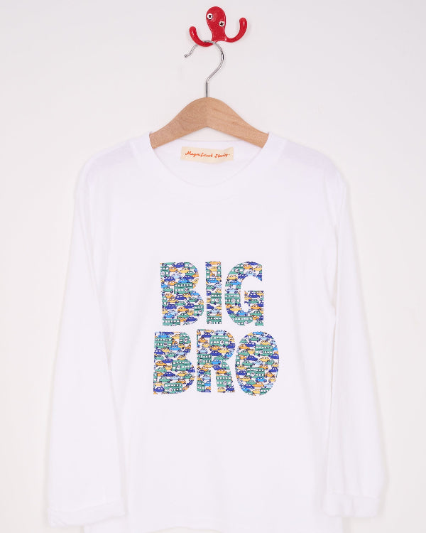 A white cotton t-shirt with BIG BRO sewn onto it in vintage liberty cars print, hanging against a wall
