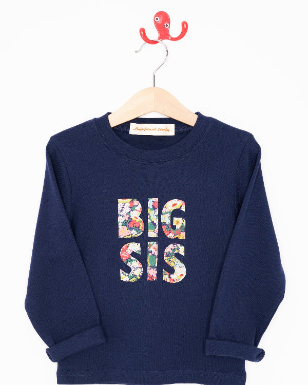 A navy cotton t-shirt with BIG SIS in floral letters on the front. the letters are cut from Liberty print and appliquéd on.