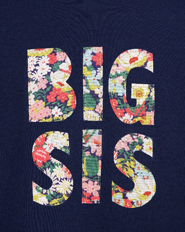 A close up of a navy cotton t-shirt with BIG SIS in floral letters on the front. the letters are cut from Liberty print and appliquéd on.