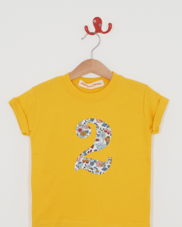 a yellow birthday t-shirt with a number 2 cut from betsy grey liberty floral print on the front.