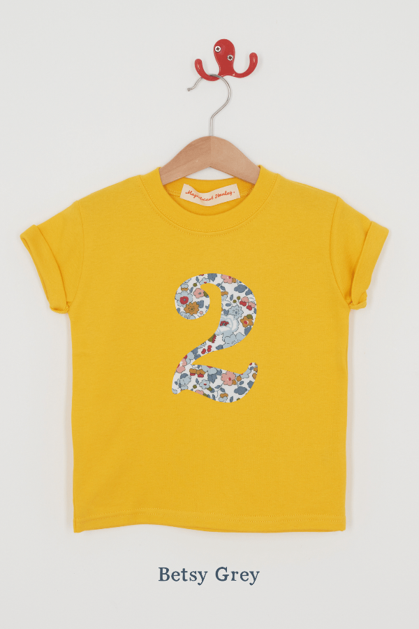 a yellow birthday t-shirt with a number 2 cut from betsy grey liberty floral print on the front.