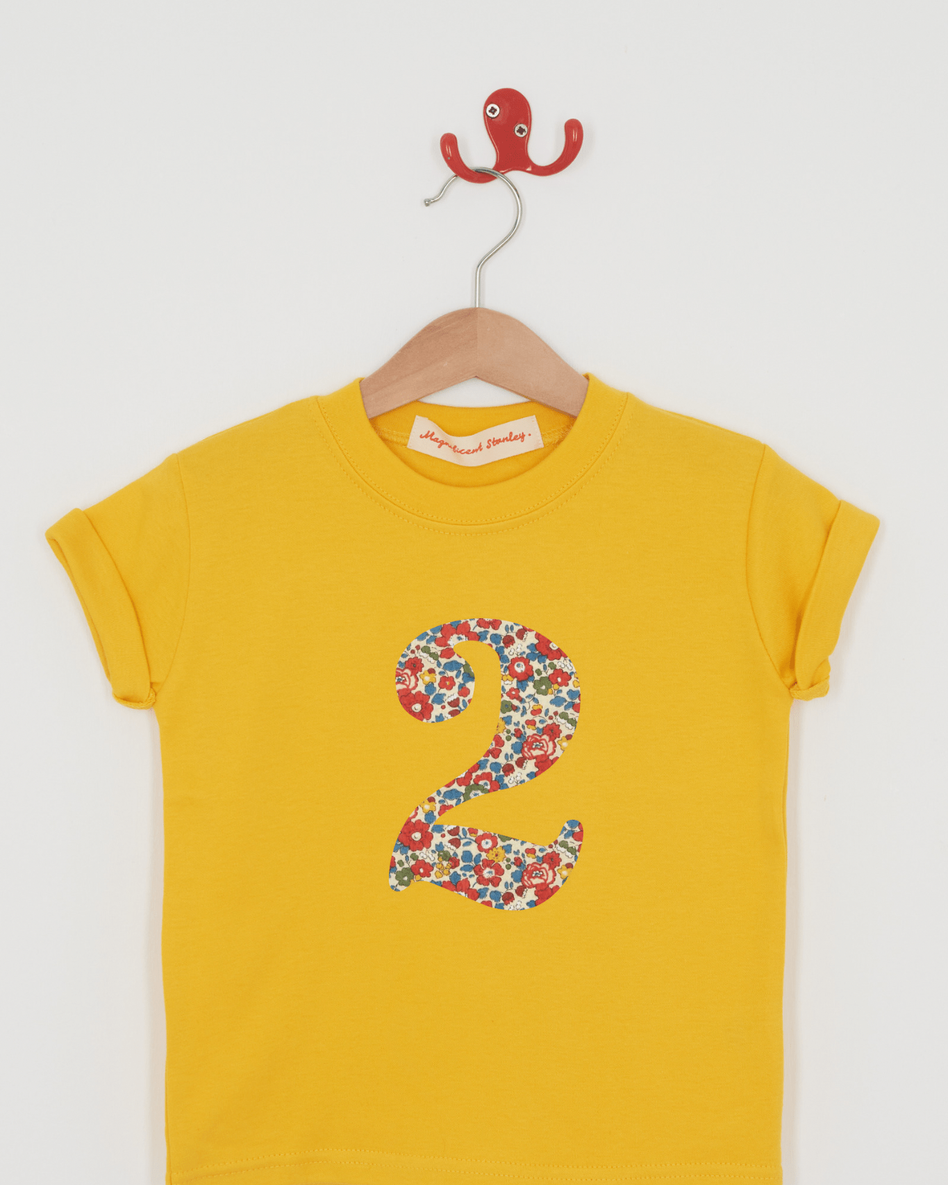 a yellow birthday t-shirt with a number 2 cut from liberty betsy ann floral print on the front
