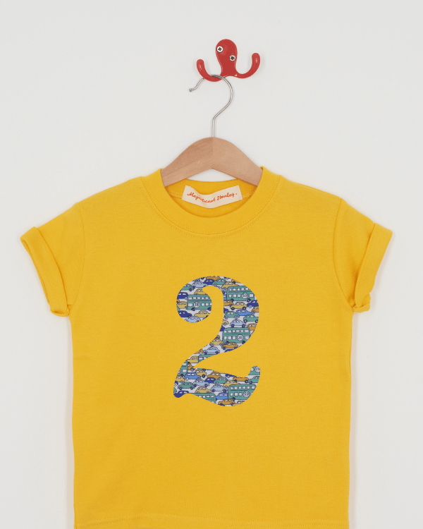 a yellow birthday t-shirt with a number 2 cut from hop on hop off liberty cars print on the front.