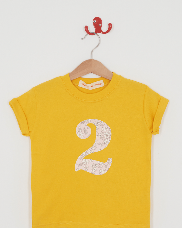 a yellow birthday t-shirt with a number 2 cut from capel pink liberty floral print on the front.