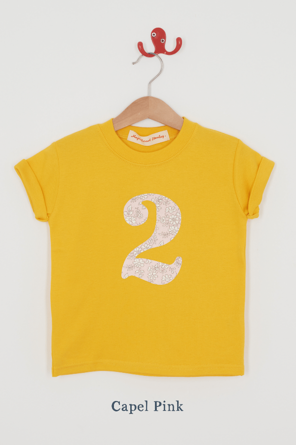 a yellow birthday t-shirt with a number 2 cut from capel pink liberty floral print on the front.