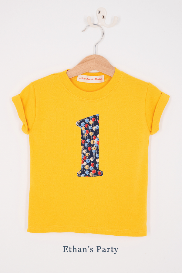 a yellow birthday t-shirt with a number 1 cut from ethan's party balloon liberty floral print on the front.