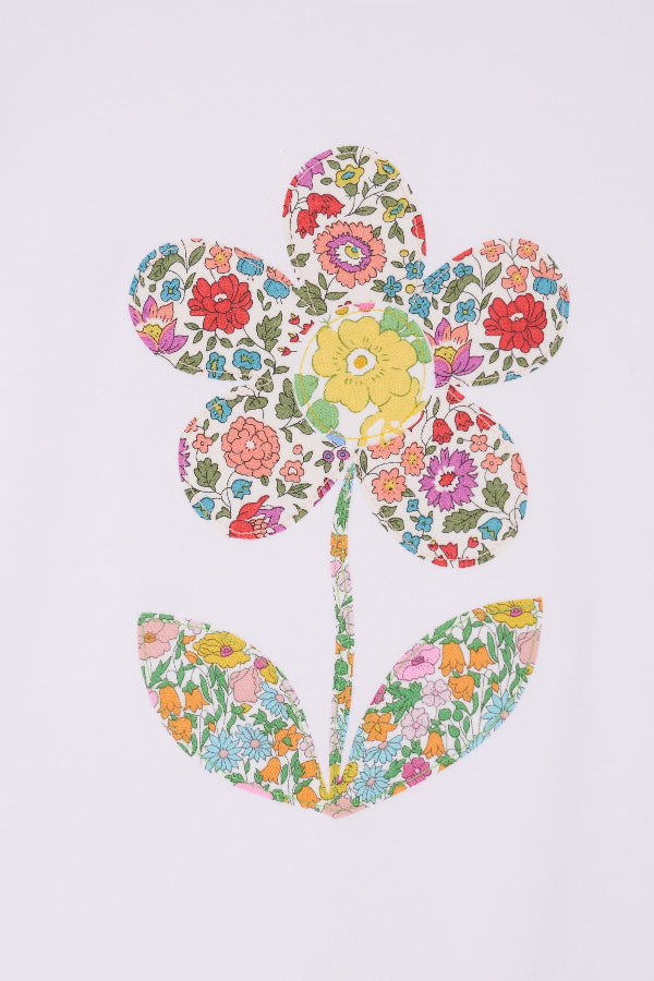 a white cotton kids Tee with a flower sewn on the front in floral liberty prints.