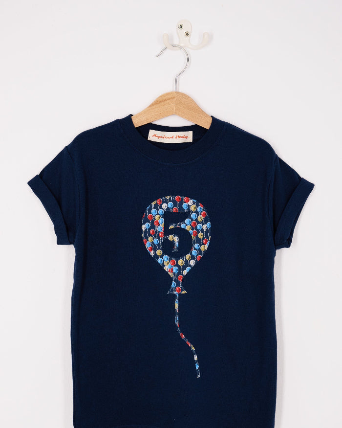 A navy t-shirt with a number 5 in a balloon on the front. The balloon is cut from Ethan's Party balloon Liberty print.