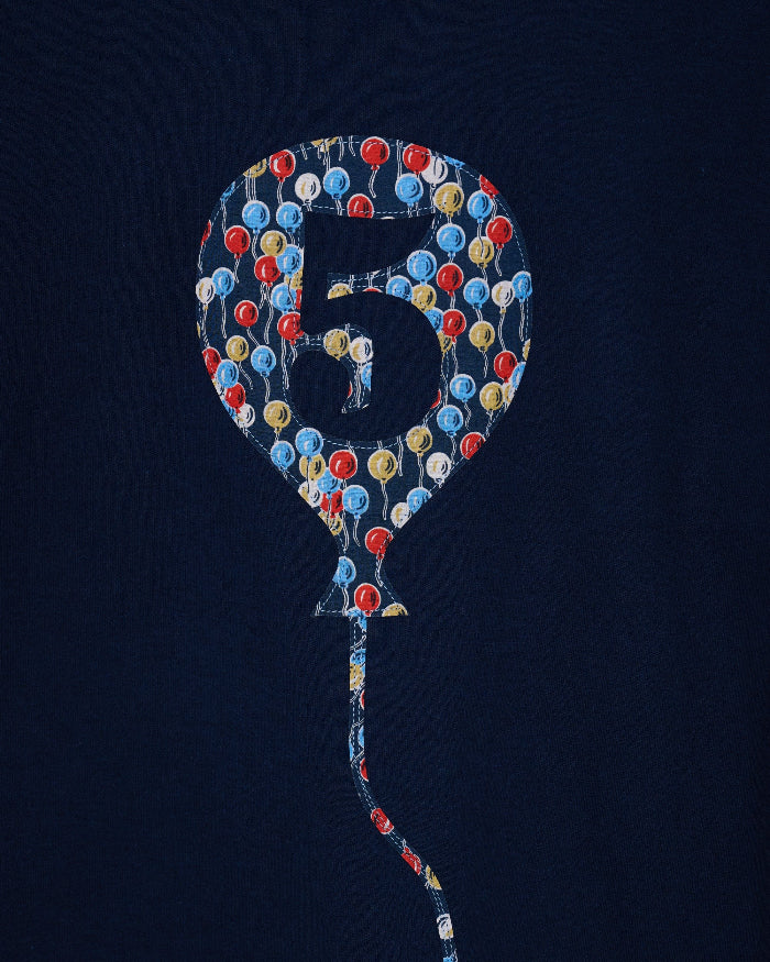 A navy t-shirt with a number 5 in a balloon on the front. The balloon is cut from Ethan's Party balloon Liberty print.