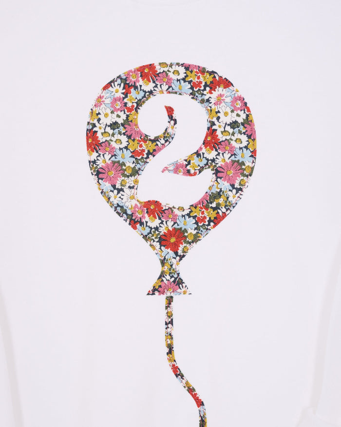 A close up of a 2nd birthday white t-shirt with a balloon and number 2 on it made from Liberty Floral print fabric.