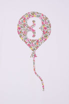A close up of a 3rd birthday white t-shirt with a balloon and number 3 on it made from Liberty Floral print fabric.