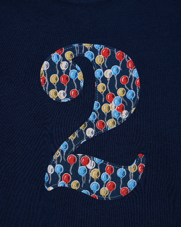 a close up of the appliqué kids Number 4 cotton Navy birthday T-Shirt in Ethan's Party Liberty Print.