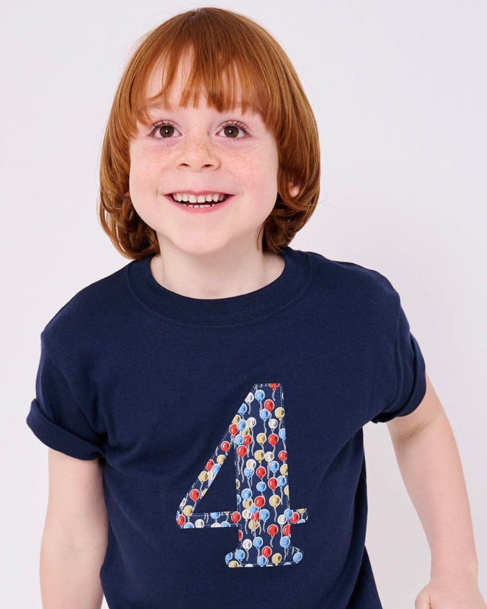 a birthday boy wearing a kids Number 4 Navy T-Shirt in Ethan's Party balloon Liberty Print.