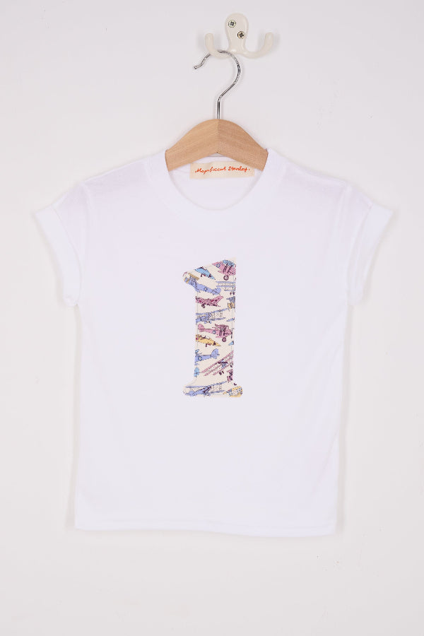 a white cotton t-shirt with a number 1 sewn on the front made from Tom's Jet plane Liberty fabric.
