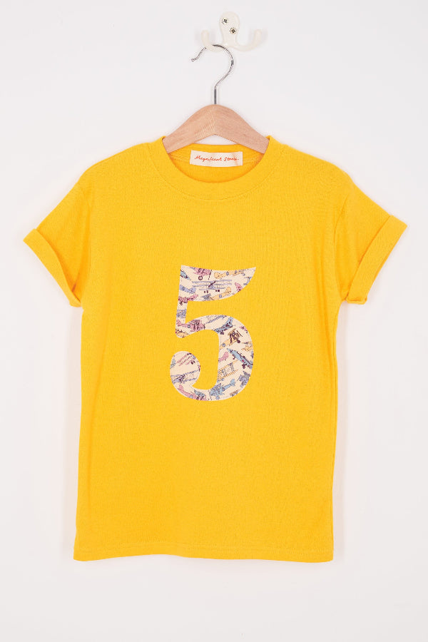 a yellow cotton t-shirt with a number 5 sewn on the front made from Tom's Jet plane Liberty fabric.