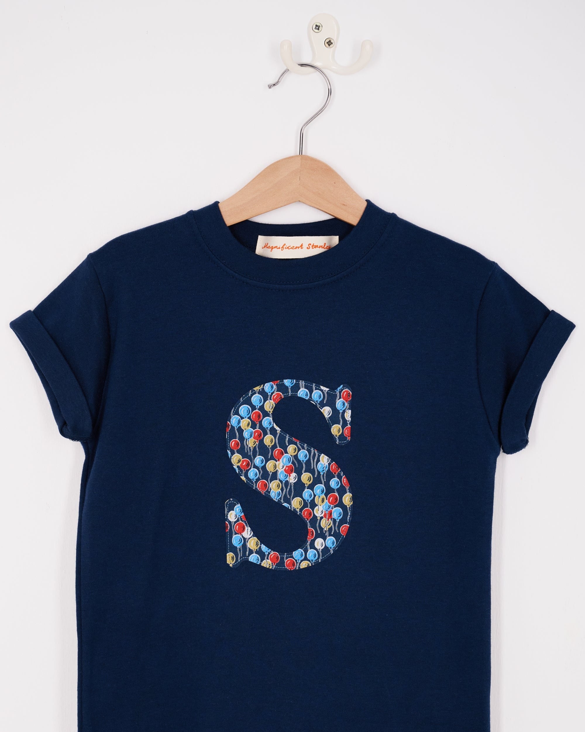 A navy cotton personalised t-shirt with an initial in Liberty balloon print.