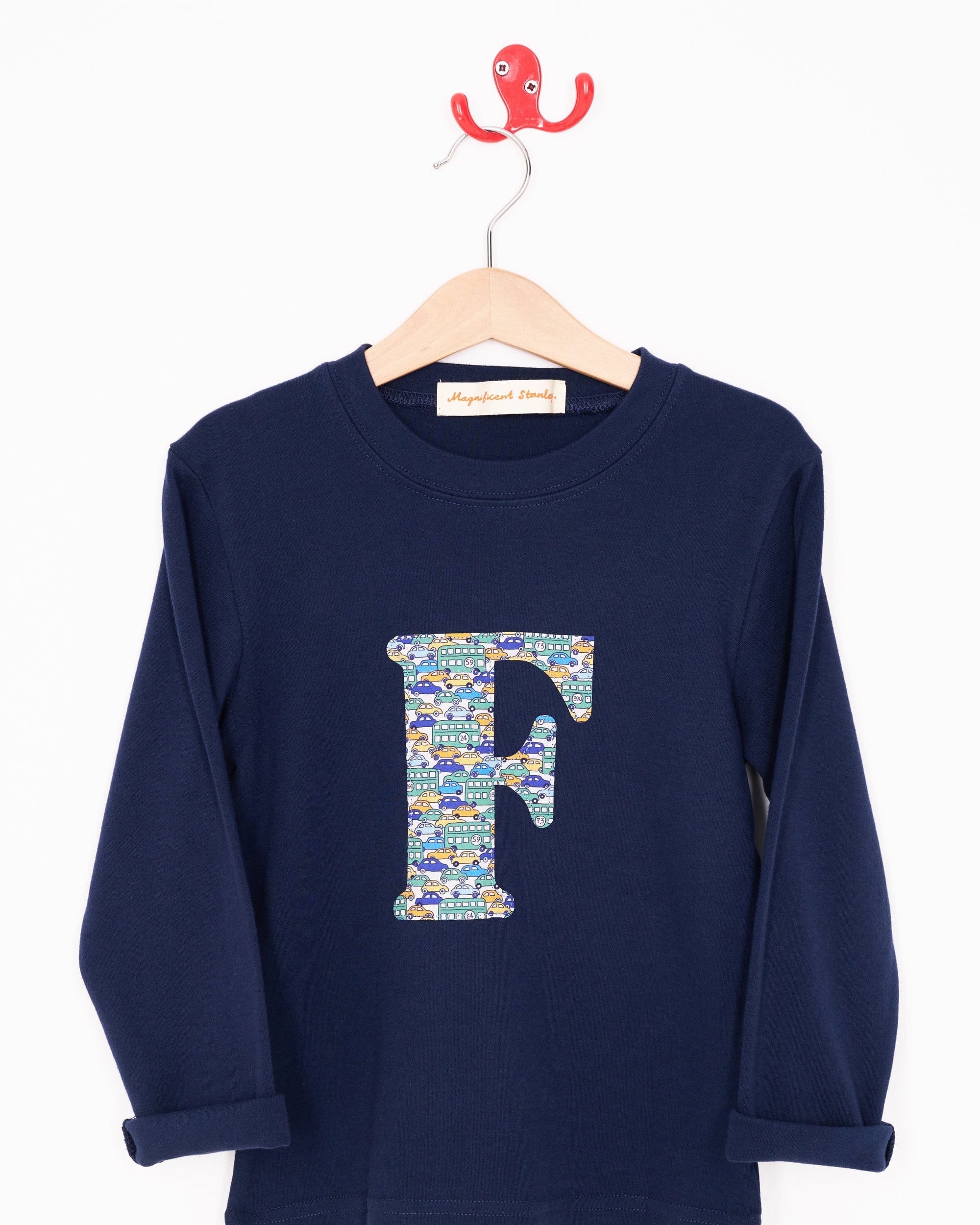 A personalised cotton long sleeve navy t-shirt with an initial on the front made from Liberty cars print.
