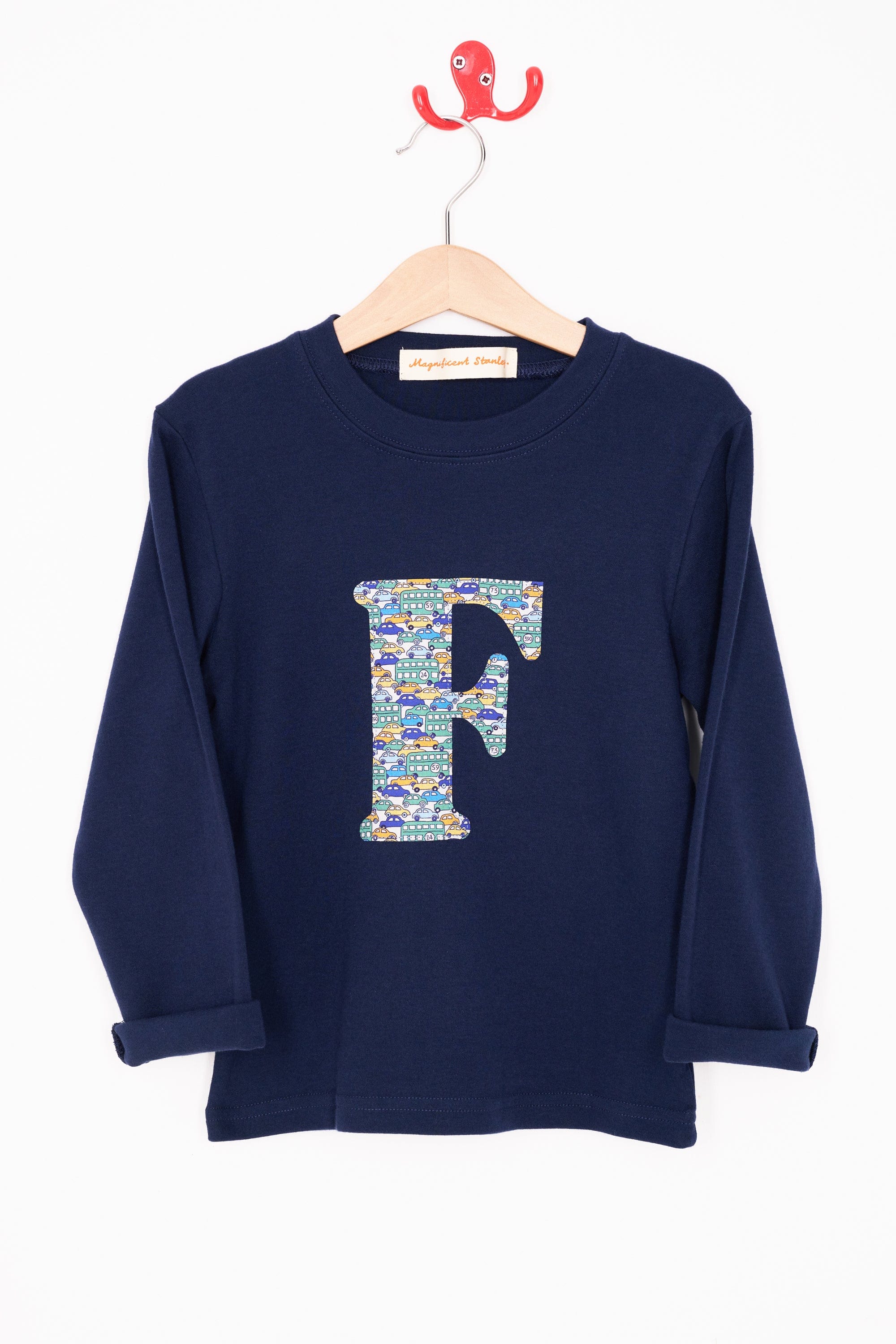 A personalised cotton long sleeve navy t-shirt with an initial on the front made from Liberty cars print.