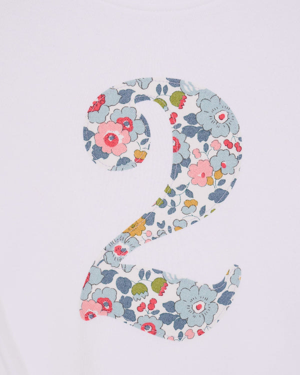 a white kids t-shirt with the number 2 in Betsy Grey Liberty Print. a close up of the stitching