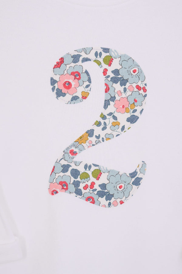 a white kids t-shirt with the number 2 in Betsy Grey Liberty Print. a close up of the stitching