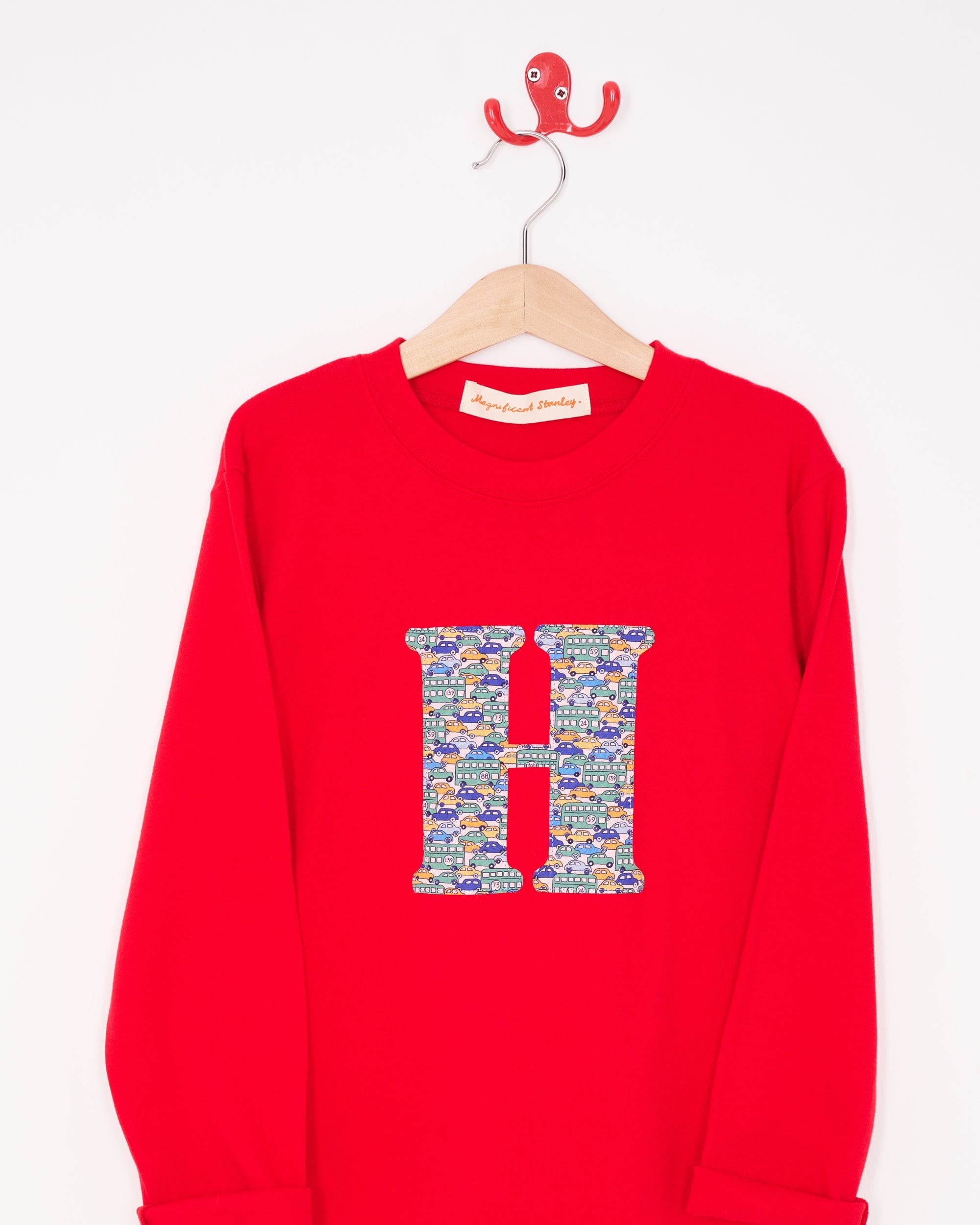 A personalised red t-shirt with an initial made from a liberty vintage cars print on the front.