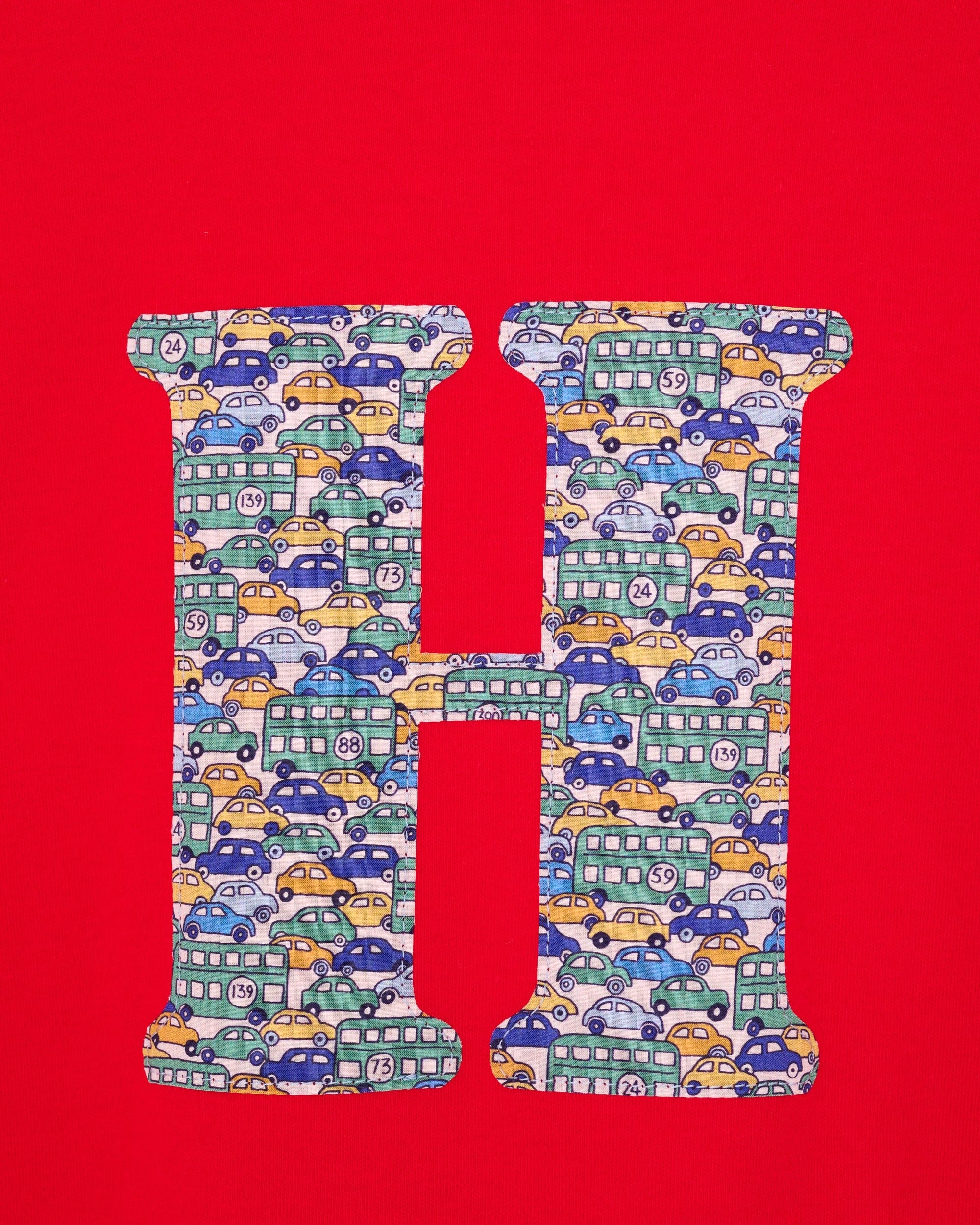 A personalised red t-shirt with an initial made from a liberty vintage cars print on the front.