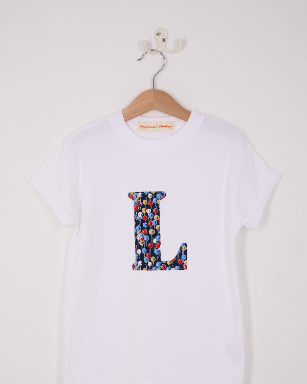 a personalised white cotton T-Shirt with an initial letter in Ethan's Party balloon Liberty Print.