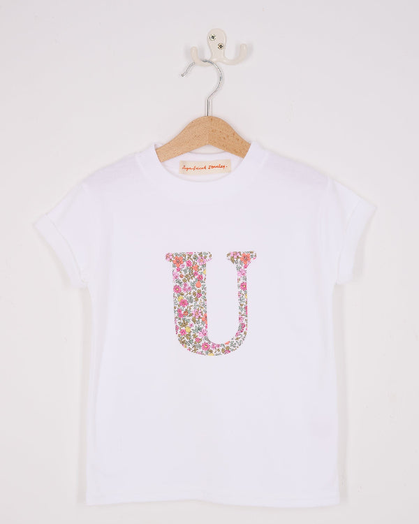 a personalised white cotton T-Shirt with her initial letter on the front in Fruit Punch Liberty Print.