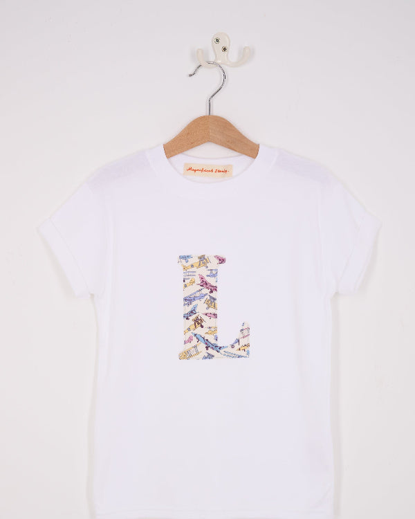 a personalised white cotton T-Shirt with an initial letter on the front in Toms Jet plane Liberty print