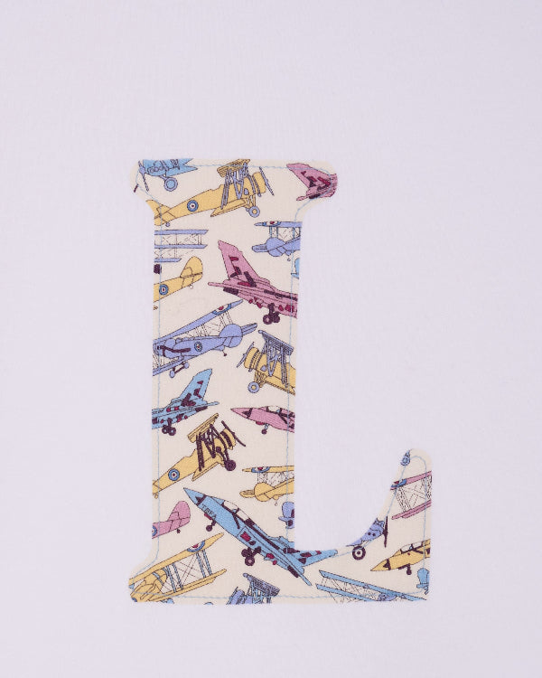 a personalised white cotton T-Shirt with an initial letter on the front in Toms Jet plane Liberty print