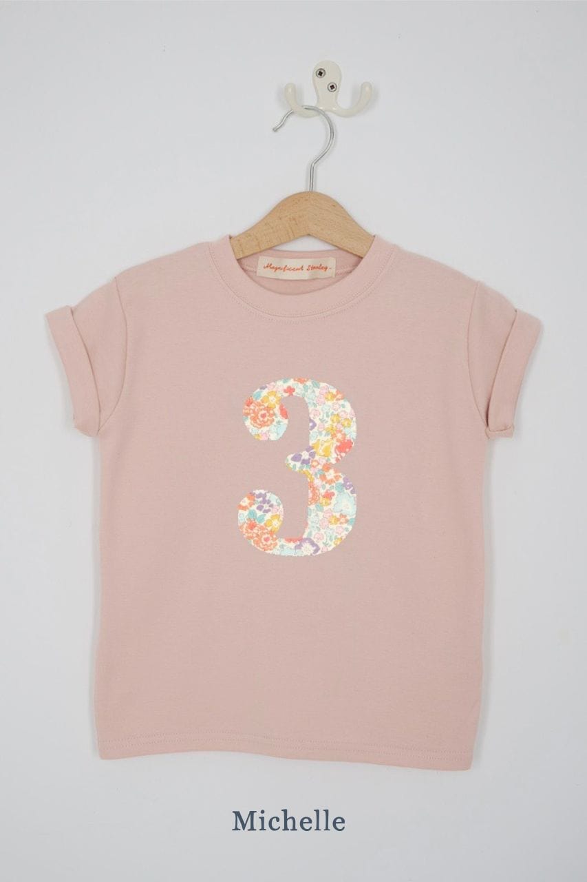 a pink 3rd birthday t-shirt with a number 3 cut from michelle liberty floral print on the front