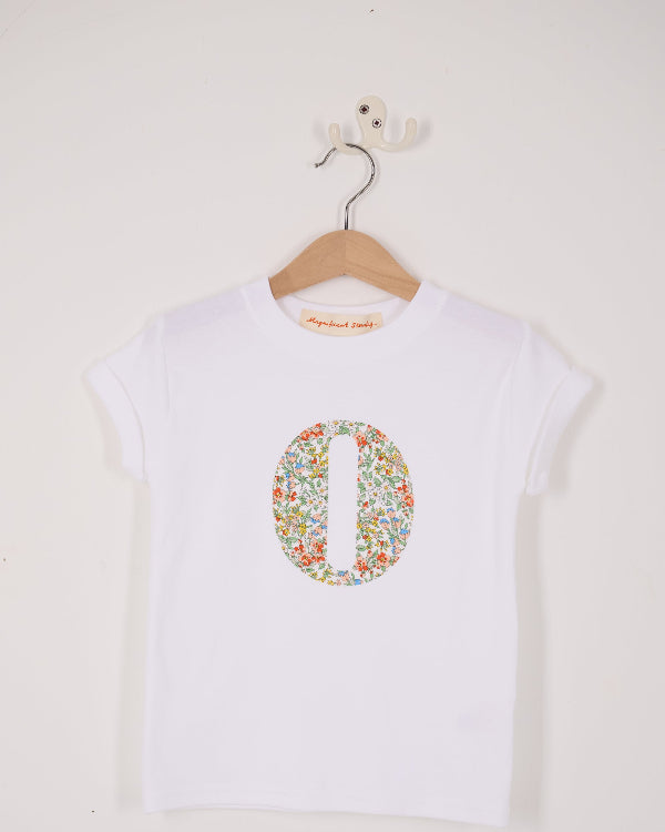 A summery personalised white cotton t-shirt with an initial cut from Nazanin floral liberty fabric.