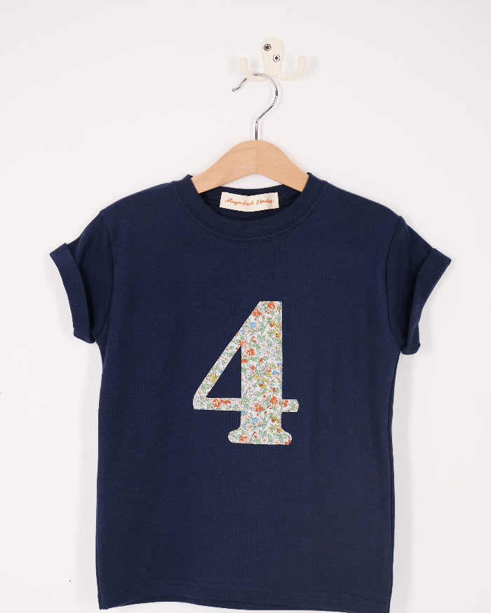 A close up of a navy cotton t-shirt with the number 4 sewn on the front cut from liberty floral Nazanin print.
