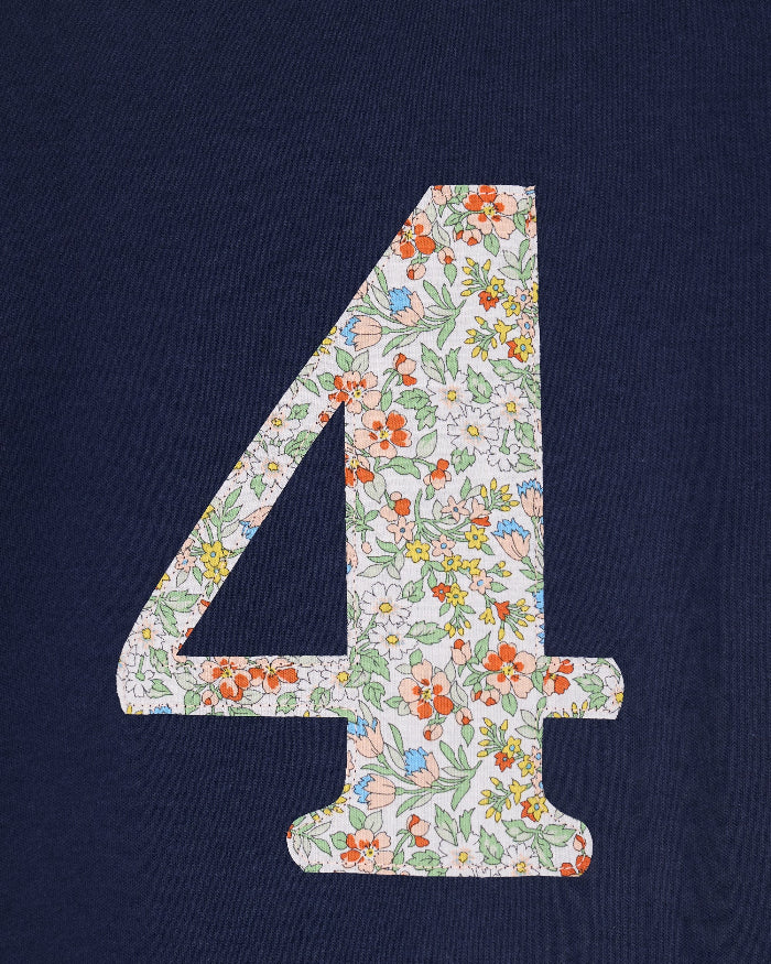 A close up of a navy cotton t-shirt with the number 4 sewn on the front cut from liberty floral Nazanin print.