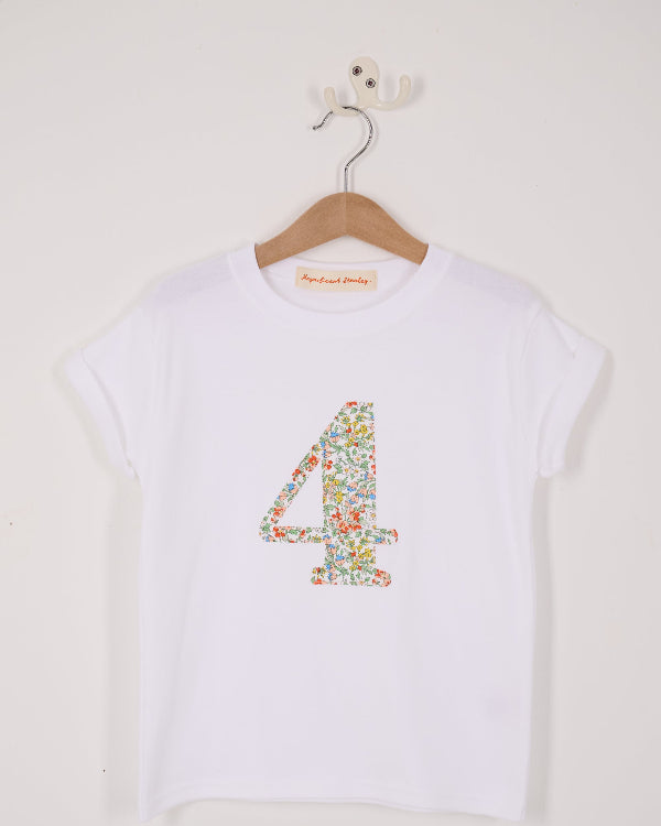A white cotton birthday t-shirt with the number 4 sewn on the front cut from liberty Nazanin fabric