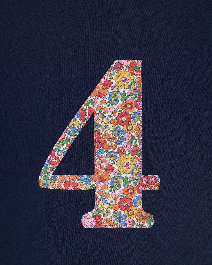 A close up of a navy cotton t-shirt with the number 4 sewn on the front cut from liberty floral Nell Annie and May print.