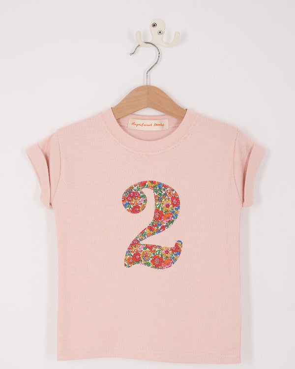 a pale pink t-shirt with a Liberty Nell Annie and May floral number '2' on the front