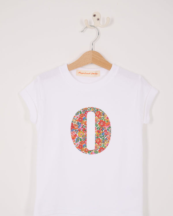 A summery personalised white cotton t-shirt with her initial cut from Nell Annie and May floral liberty fabric.