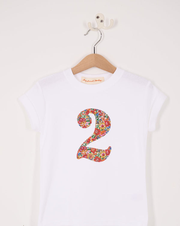 A white cotton birthday t-shirt with the number 2 sewn on the front cut from liberty Nell Annie and May fabric