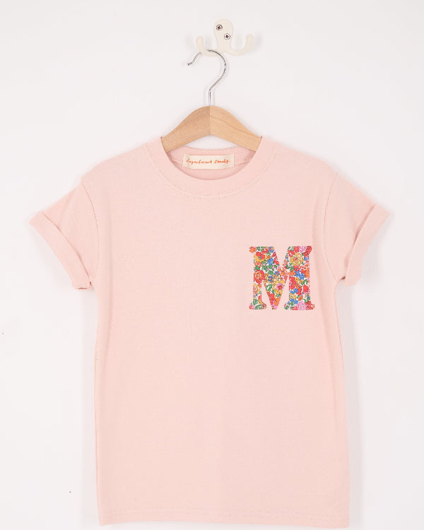 a pale pink t-shirt with a Liberty Nell Annie and May floral small initial on the front