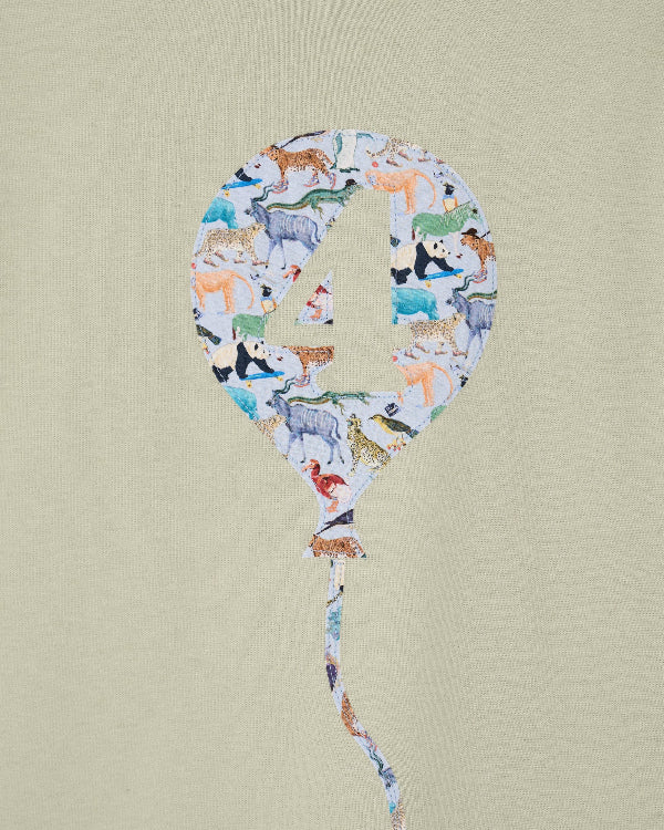 Balloon-shaped number '4' with animal pattern on a beige background