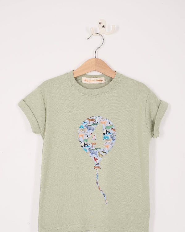 a sage green t-shirt with a colourful number balloon design made from animal liberty print