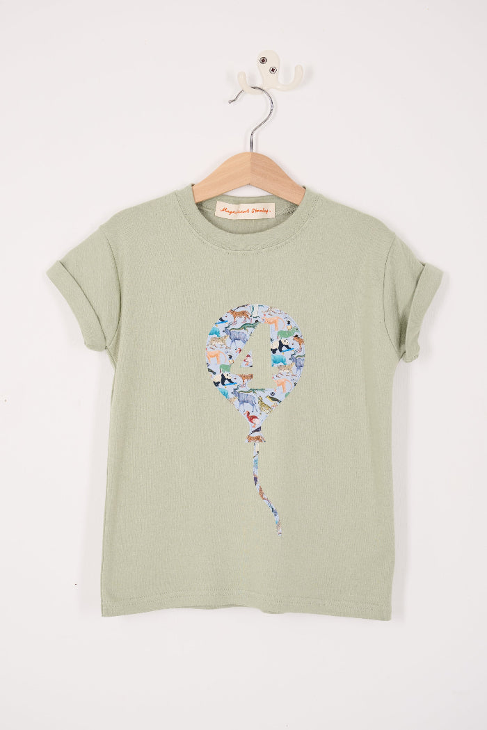 Green t-shirt with a colourful number 4 balloon design on a hanger against a white background