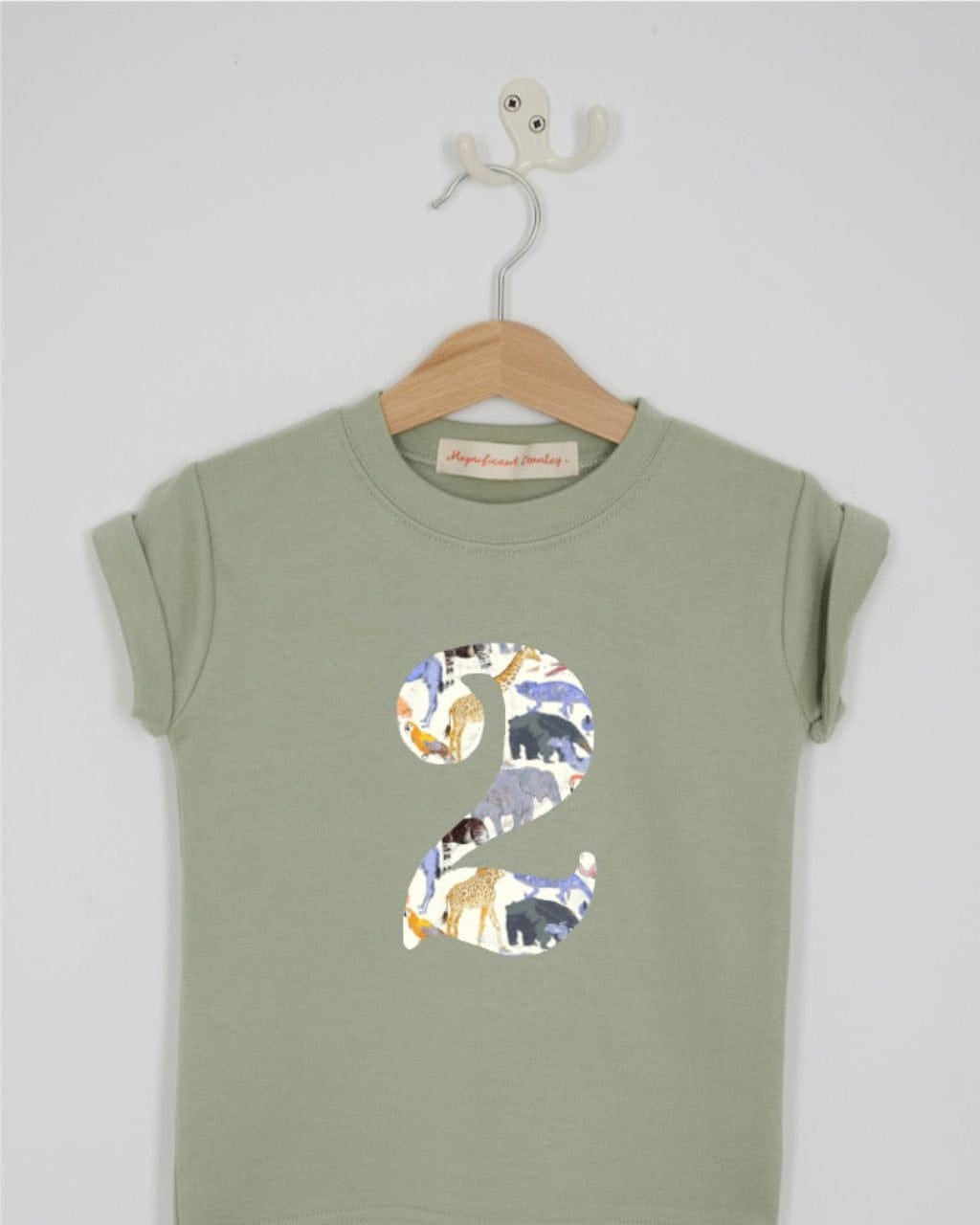 a number 2nd birthday kids sage green t-shirt with a number cut from queue for the zoo animal liberty print on the front.