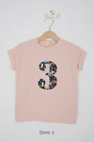 a pink 3rd birthday t-shirt with a number 3 cut from quey 2 liberty zoo animal print on the front