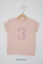a pink 3rd birthday t-shirt with a number 3 cut from sadie rose liberty floral print on the front