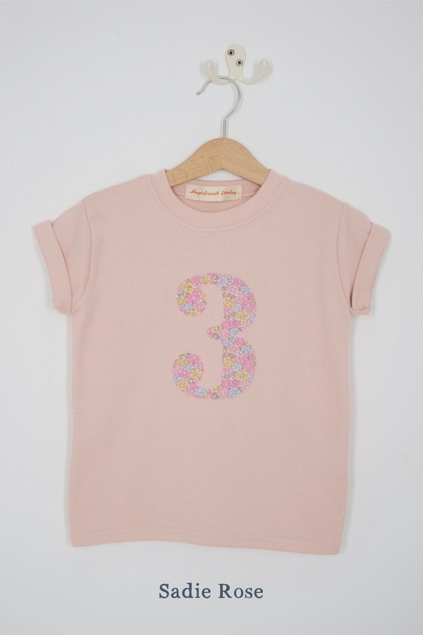 a pink 3rd birthday t-shirt with a number 3 cut from sadie rose liberty floral print on the front