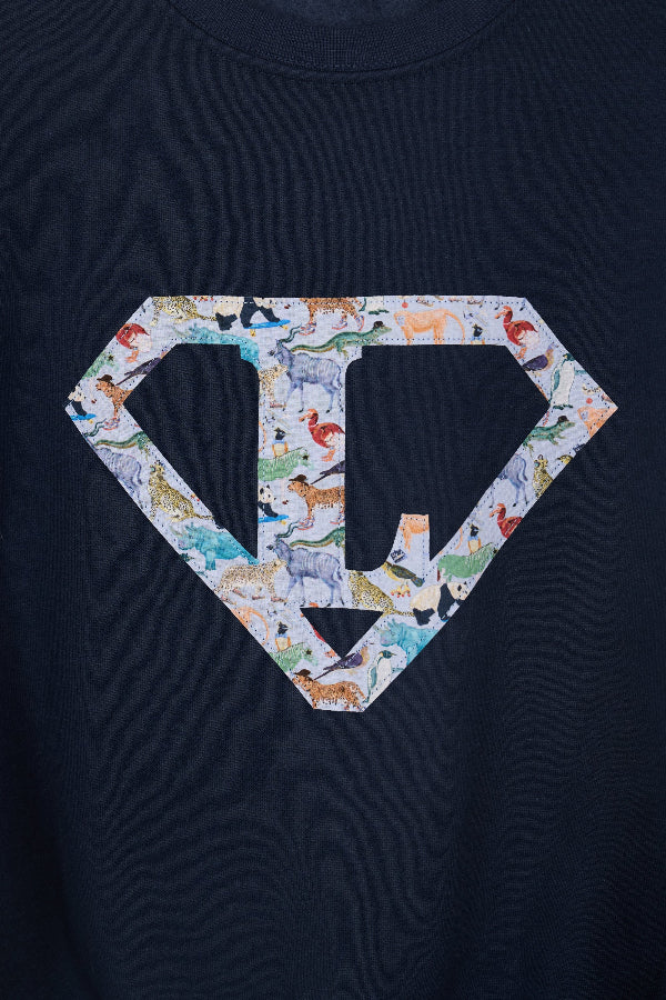 a personalised navy blue sweatshirt with an initial superhero logo on the front in Quey 2 animal liberty print