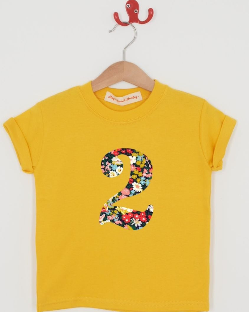 a yellow birthday t-shirt with a number 2 cut from thorpe liberty floral print on the front.